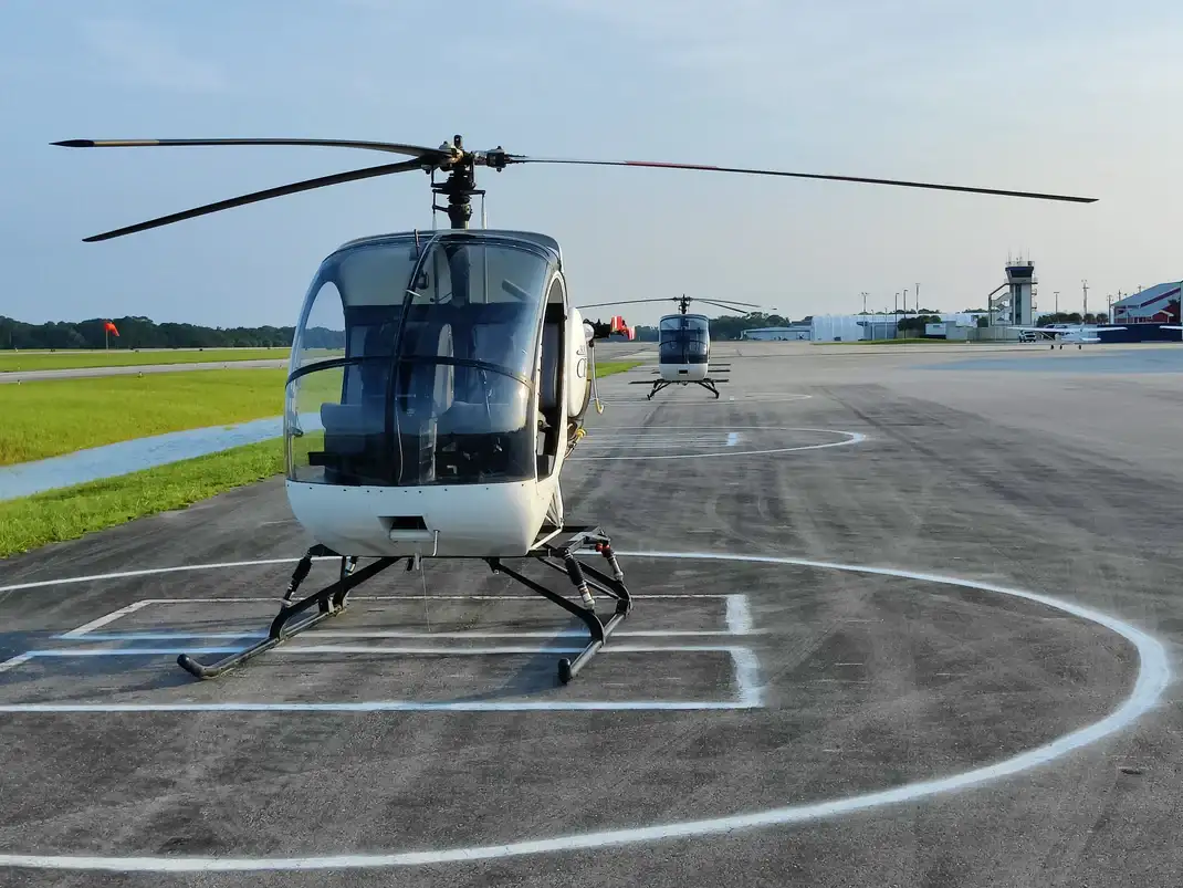Two S300 helicopters parked in a ramp