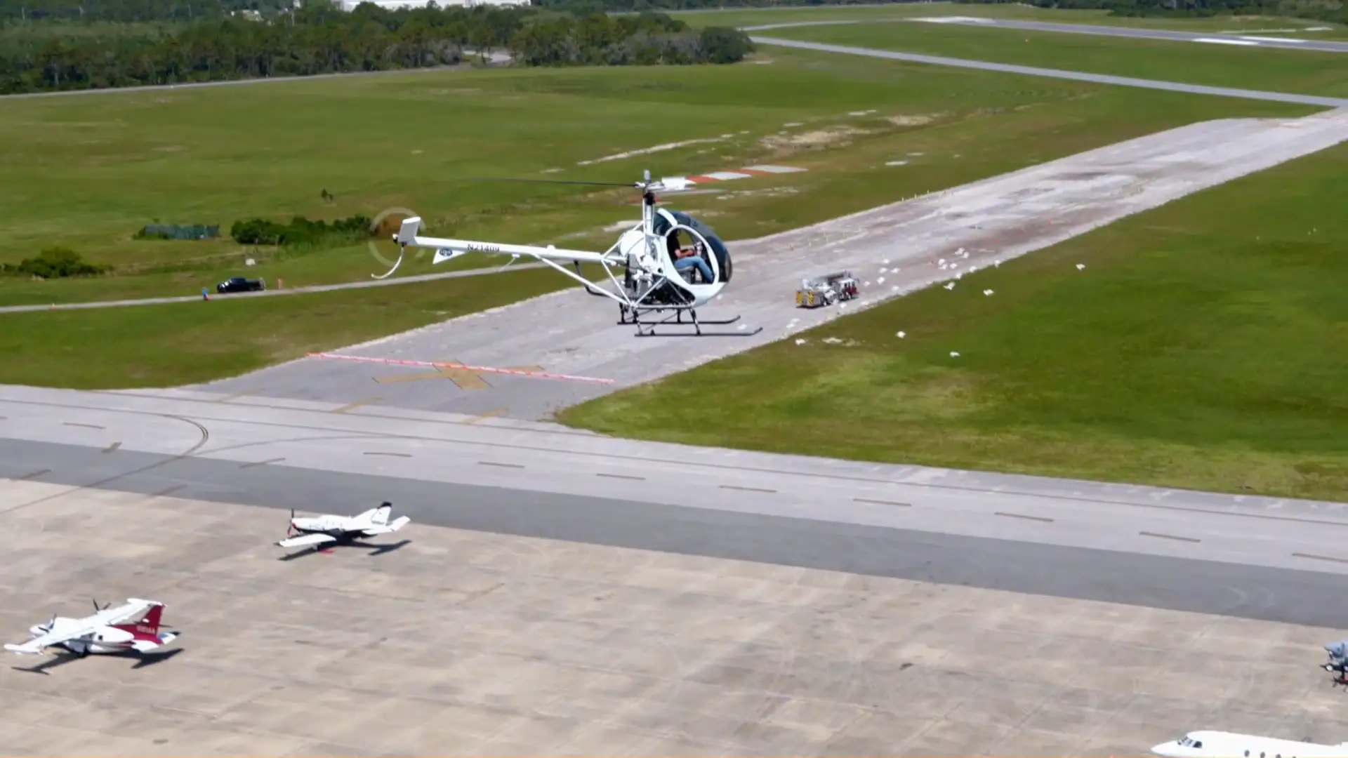 White helicopter over Florida coastline during flight training at USATS Titusville