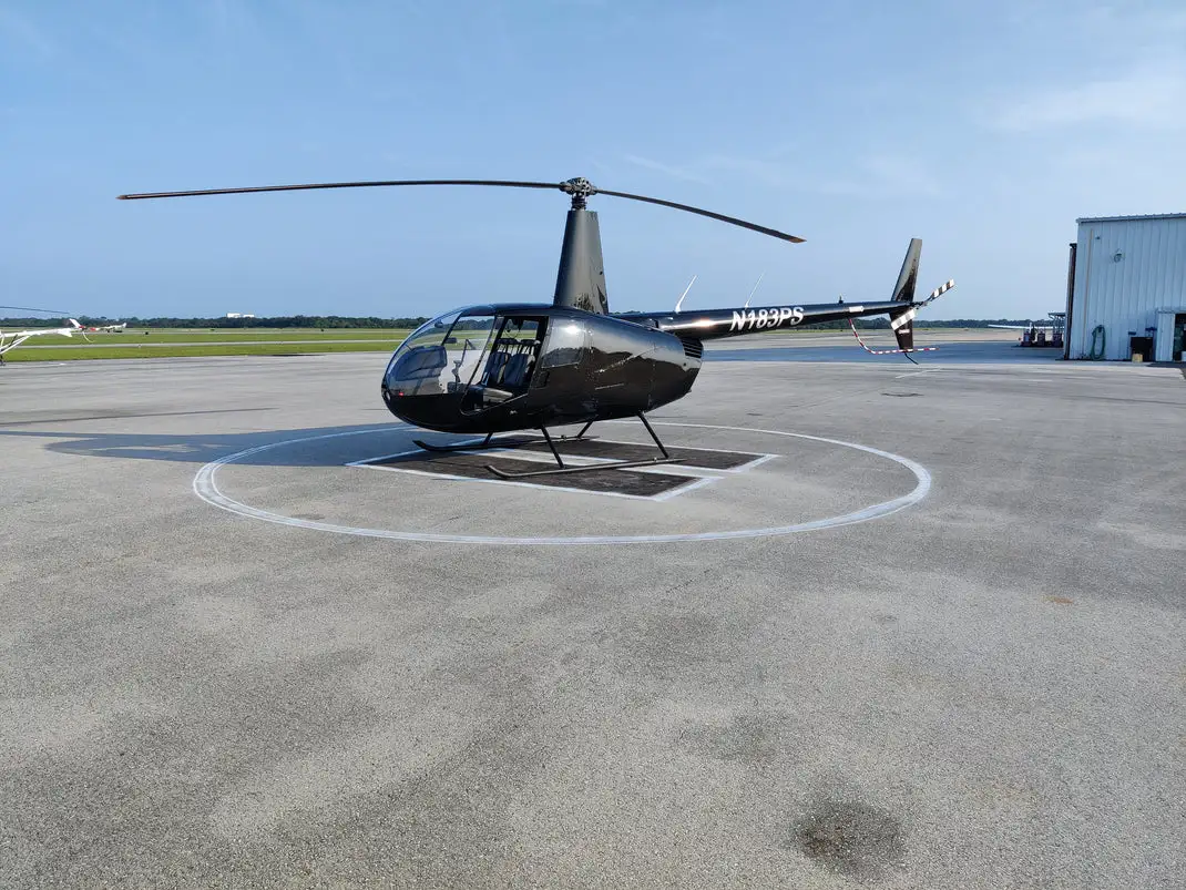 USATS training helicopter on the helipad at Space Coast Regional Airport